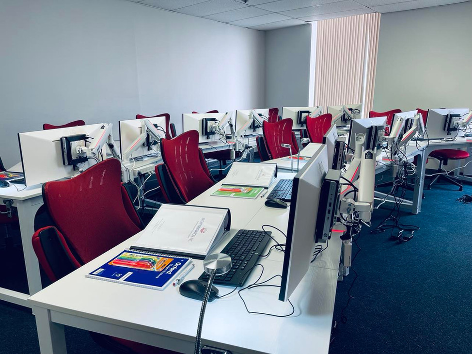 Computer workstations and course materials inside the Flight Innovation classroom